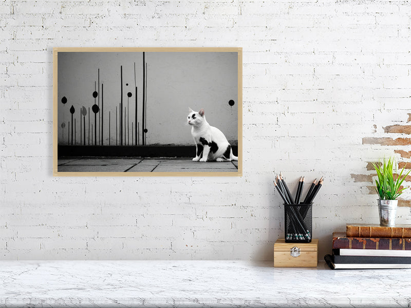 The Tale Of A Cat - Pt 1 - Shadow & Form by Elena Selene – Giclée Print, 70cm x 100cm, 27.6in x 39.4in, White Frame, placed above a sleek desk in a modern workspace