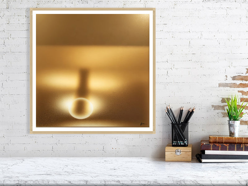 Golden Lumina - Radiant Horizon by Lucas Vale – Giclée Print, 50cm x 50cm, 19.7in x 19.7in, Oak Frame, placed above a sleek desk in a modern workspace